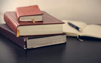 Legal books and compliance materials on a desk representing new legislation affecting employee Benefit Changes 2026.
