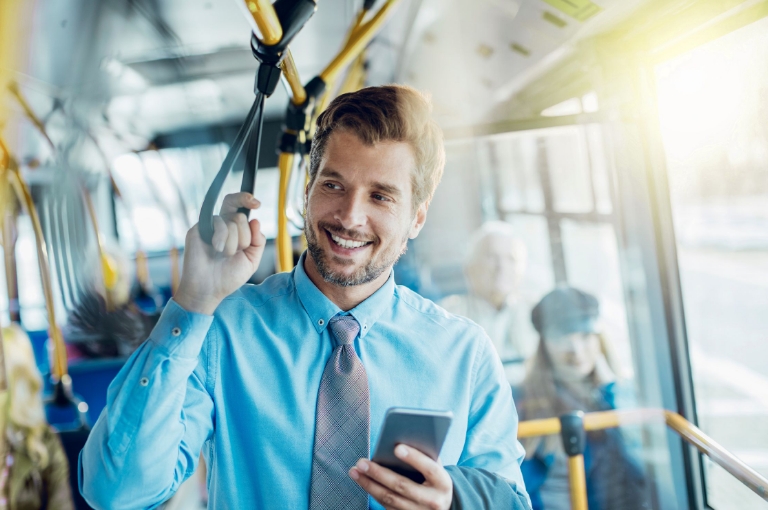 Commuters traveling to work in an urban setting, illustrating transportation savings and support with commuter benefits communication toolkits.