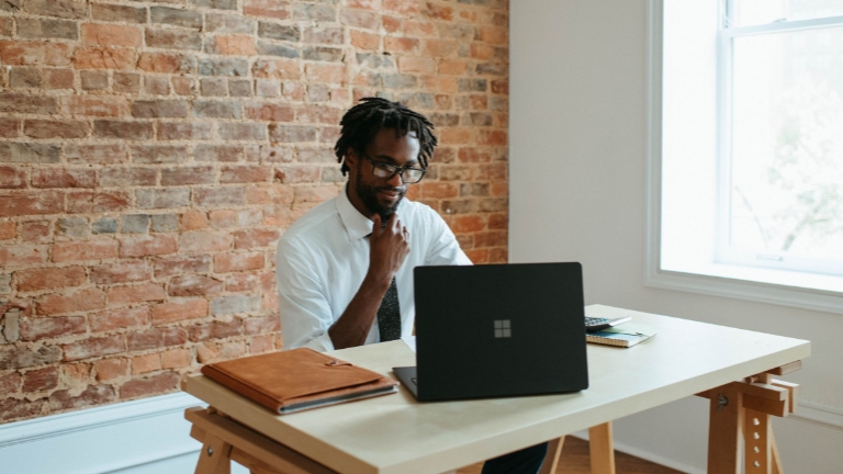 Man in office workspace focused on compliance services and accurate Form 5500 filing for employee benefits.