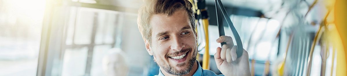 Man enjoying a stress-free ride on public transit, symbolizing the value of commuter benefits programs that support sustainable and affordable travel to work.